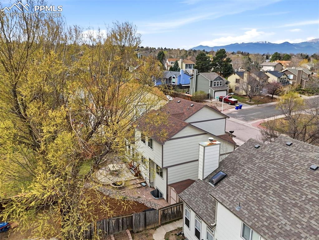 Image 37 of 46: Aerial view of residential area featuring a mountain backdrop