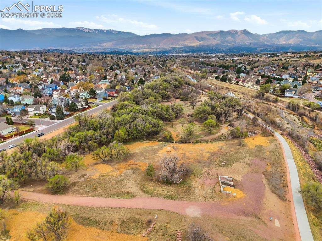 Image 43 of 46: Aerial view of residential area featuring mountains