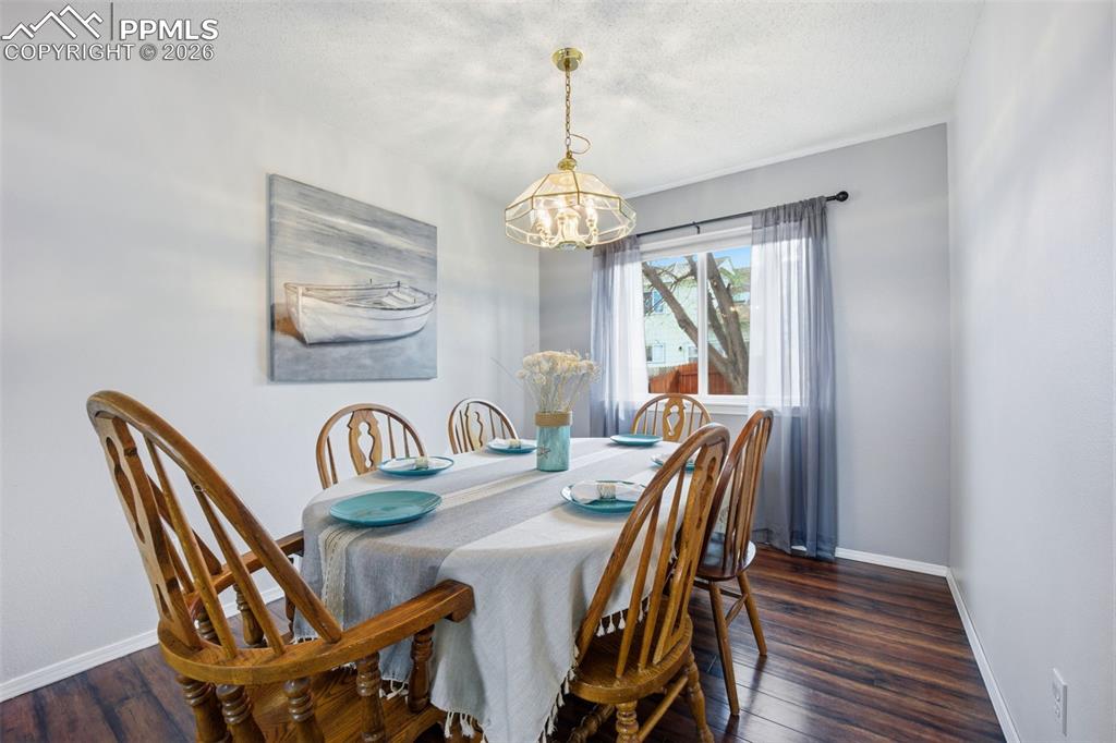 Image 6 of 46: Dining space with dark wood-style floors