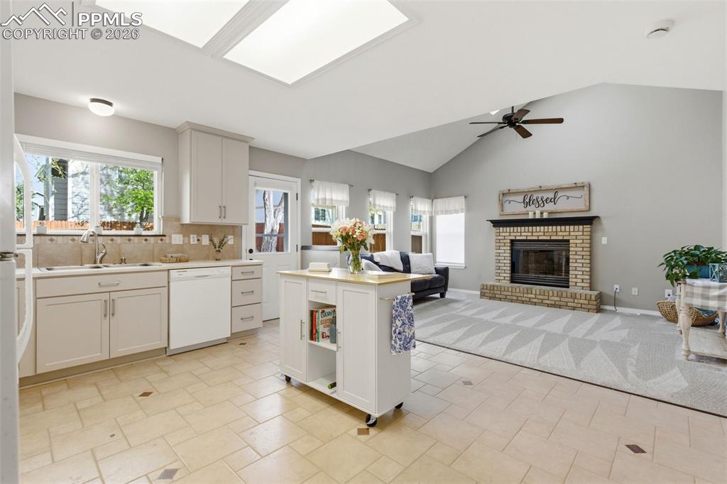 Image 8 of 46: Large kitchen with space for permanent island, new tile floor, and backspla