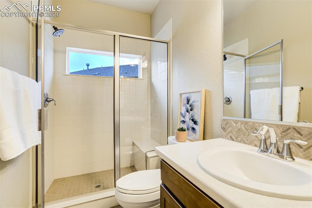 Image 25 of 49: Bathroom on the main level next to the secondary bedroom. 