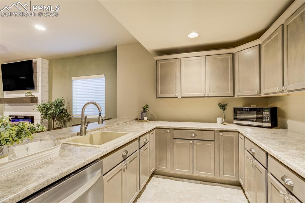 Image 29 of 49: This basement bar is bigger than most kitchens. 