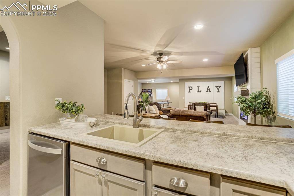 Image 35 of 49: Sink, dishwasher, and full size fridge. 