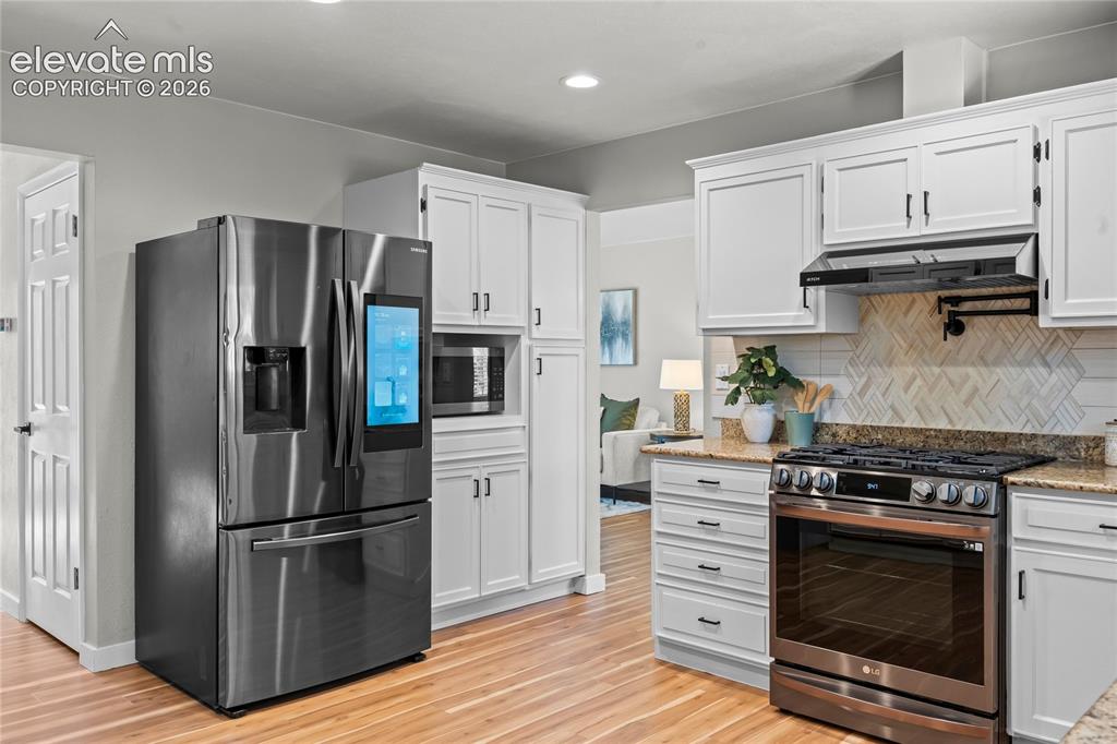 Image 13 of 50: Fully reimagined gourmet kitchen blending high-tech convenience with design