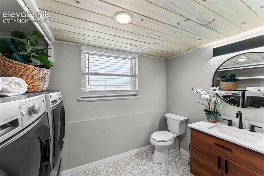 Image 33 of 50: More than just a utility space, this laundry room offers built-in designer
