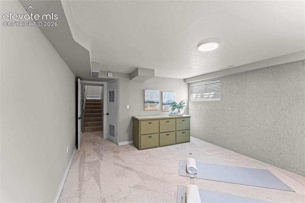 Image 35 of 50: Expansive lower-level bonus room, perfect for an exercise suite or hobby ro