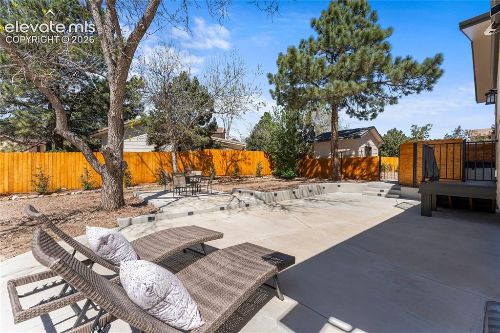 Image 38 of 50: The ultimate outdoor oasis! This massive 1,250 sq. ft. lighted patio is des