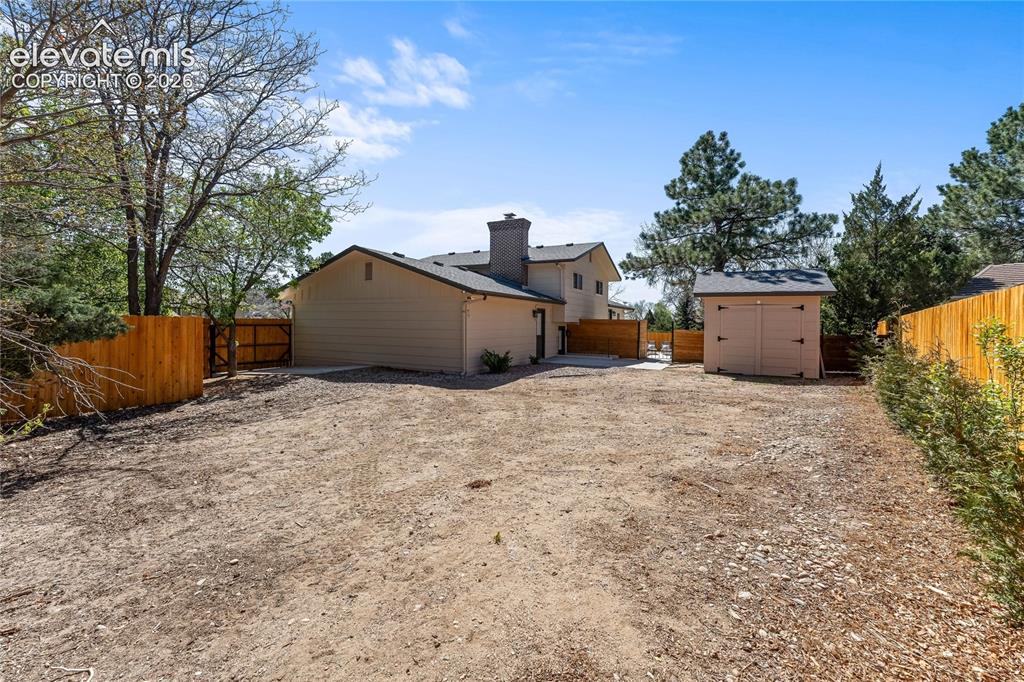 Image 44 of 50: Expansive backyard retreat featuring a massive, fully enclosed privacy fenc