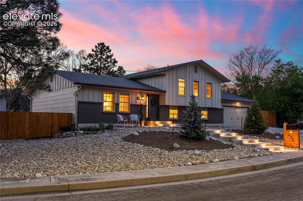 Image 48 of 50: Modern curb appeal meets mountain majesty. This contemporary split-level re