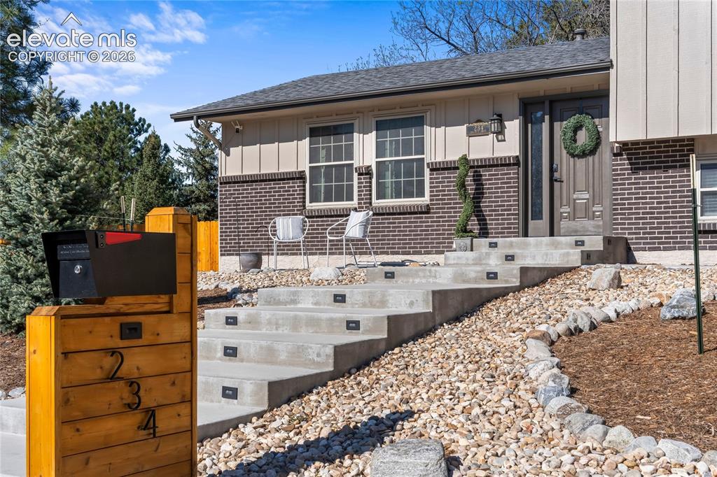Image 5 of 50: Custom, lit concrete steps leading to the front door.  Easier for guests, a