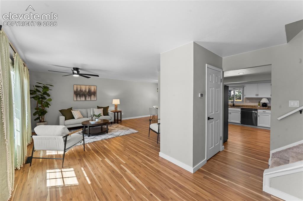 Image 7 of 50: Expansive open-concept living area bathed in natural light, featuring conte