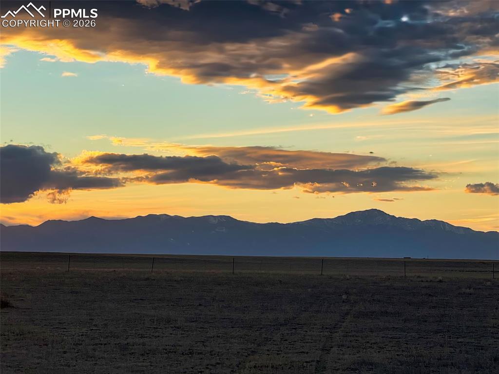 Image 6 of 10: Sunset View – Mountain Silhouette – Dramatic sunset framing the mountain sk