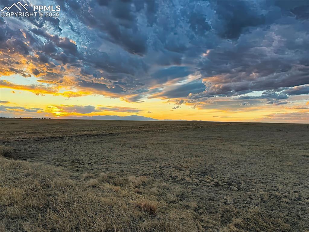 Image 8 of 10: Twilight View – Open Horizon – Soft evening light across the grassland high