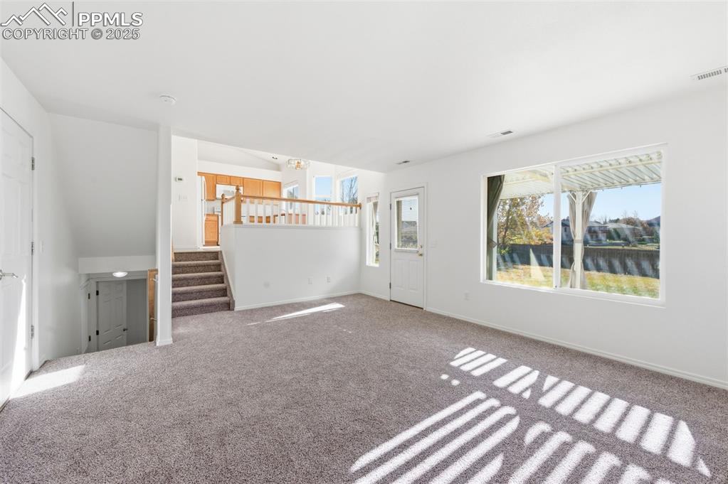 Image 11 of 45: all new carpet, gas-log fireplace