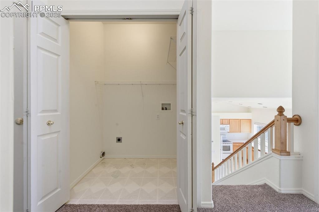 Image 19 of 45: Upper level hall laundry