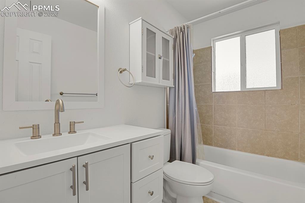 Image 10 of 19: Full bathroom with vanity and shower / bath combination with curtain