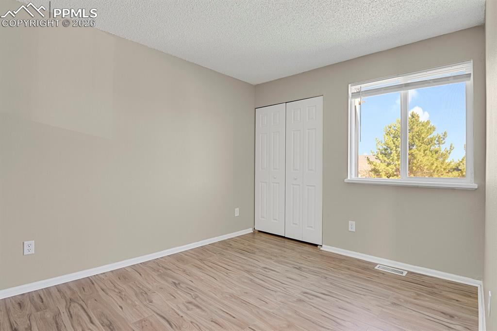 Image 11 of 19: Bedroom with light wood-type flooring, and closet