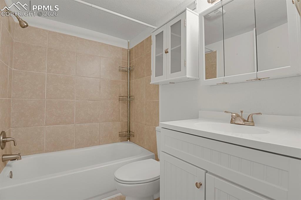 Image 16 of 19: Lowere Bathroom featuring vanity, tub / shower combination