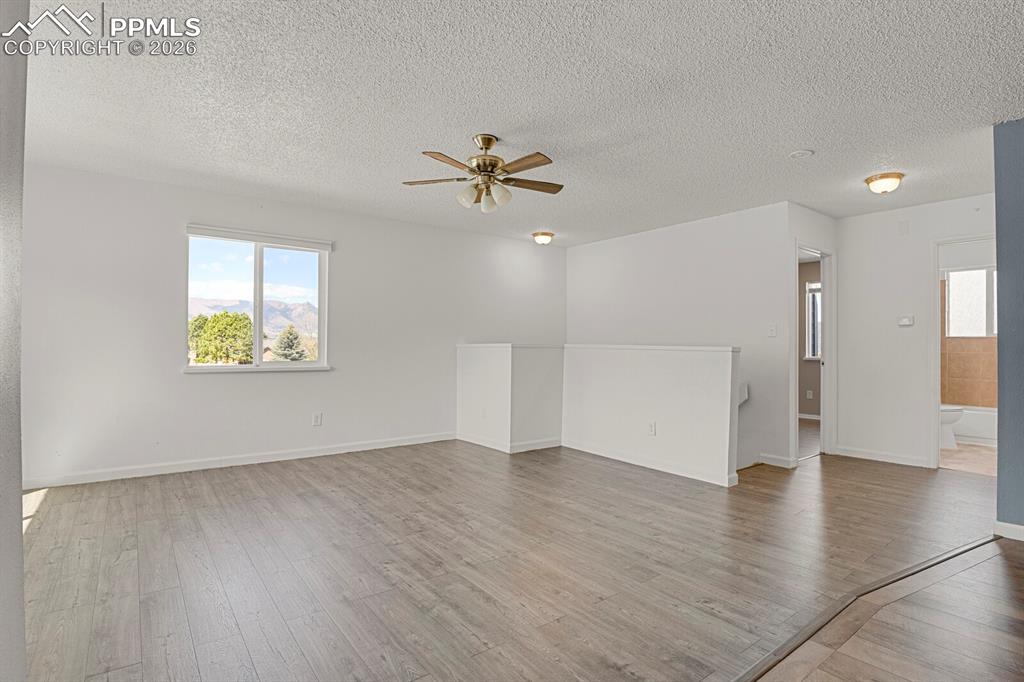 Image 3 of 19: Living room with ceiling fan, and wood finished floors
