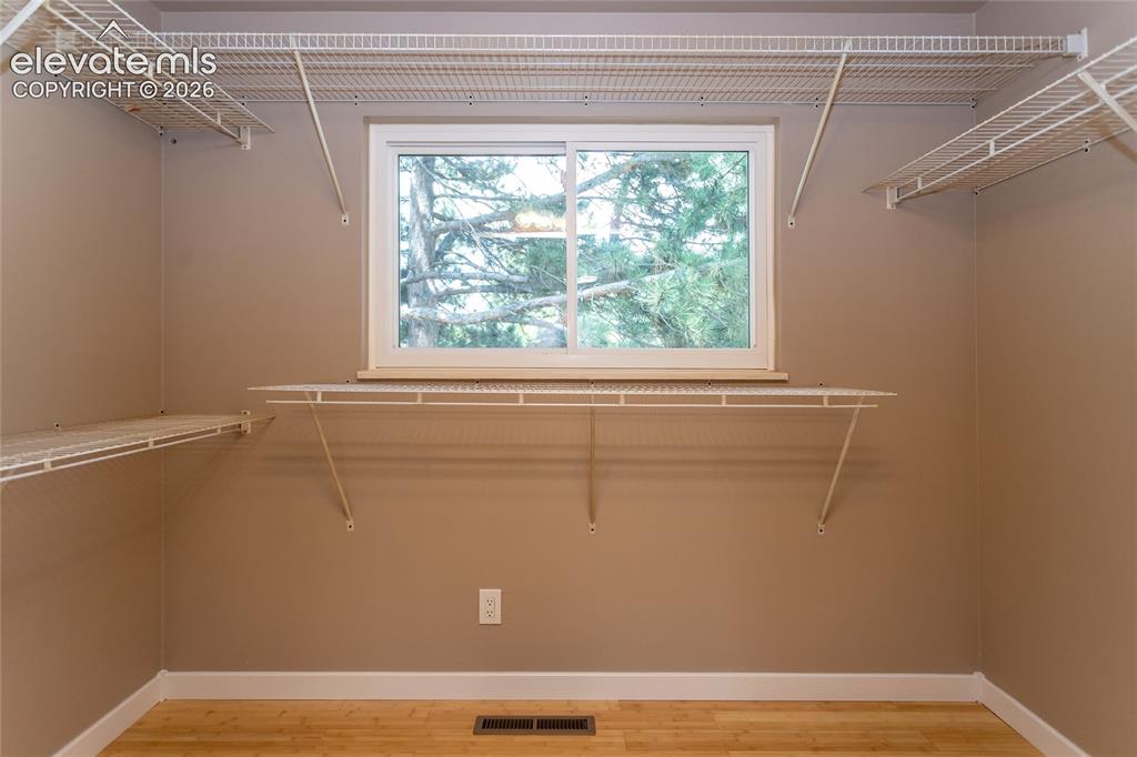 Image 18 of 46: Walk-in closet in primary bedroom