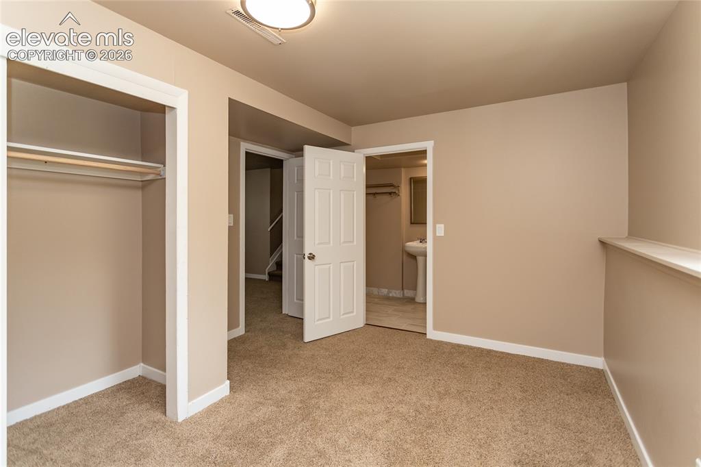 Image 31 of 46: Lower level bedroom with private bathroom