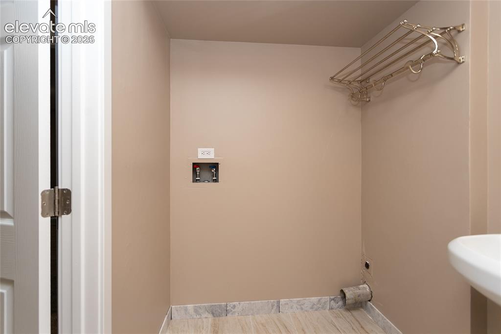 Image 32 of 46: Laundry area in lower level bathroom