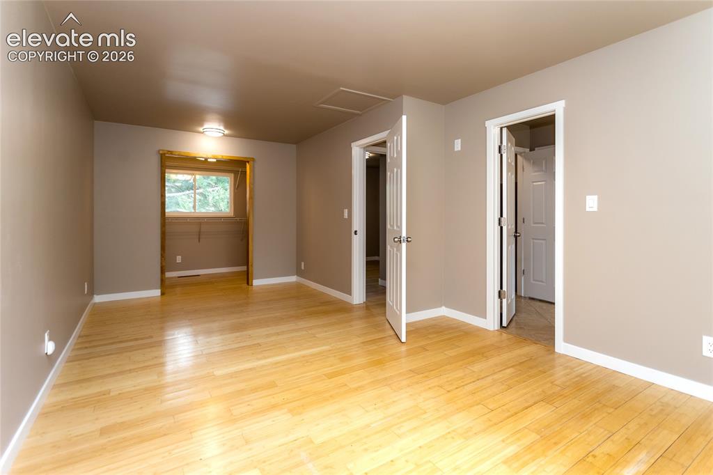 Image 4 of 46: Extended primary bedroom with walk-in closet on upper level