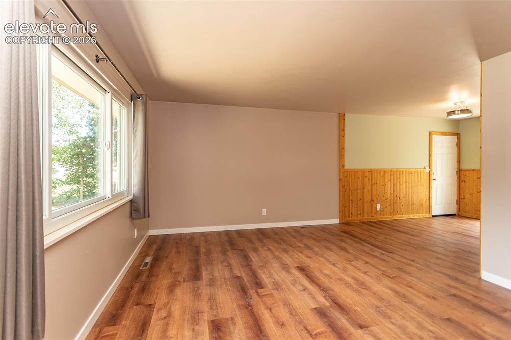 Image 6 of 46: Living room with new LVP flooring.
