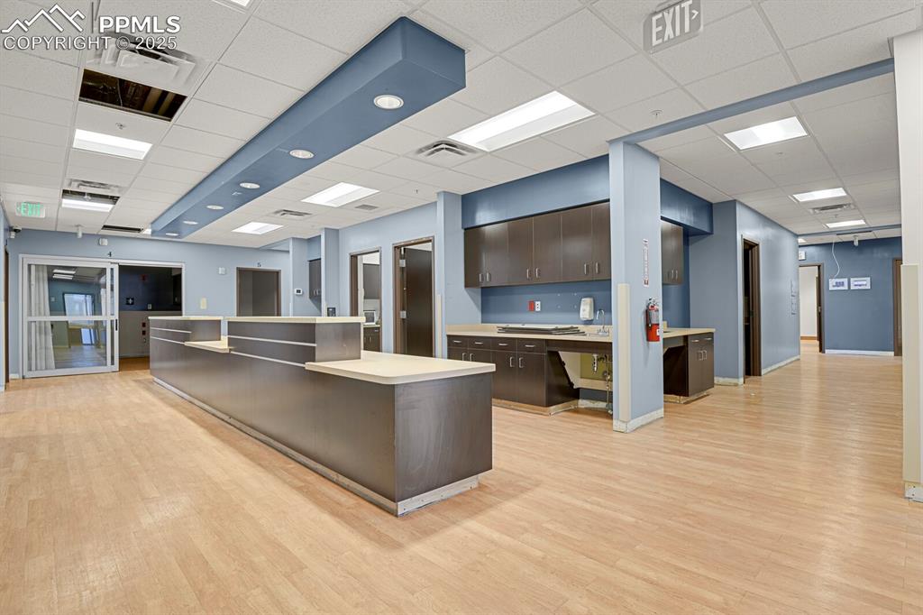 Image 19 of 50: Unfurnished office featuring a paneled ceiling and light wood-style floors