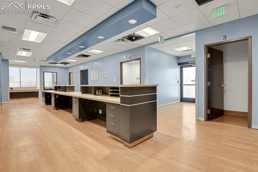Image 25 of 50: Unfurnished office with a paneled ceiling and light wood-type flooring