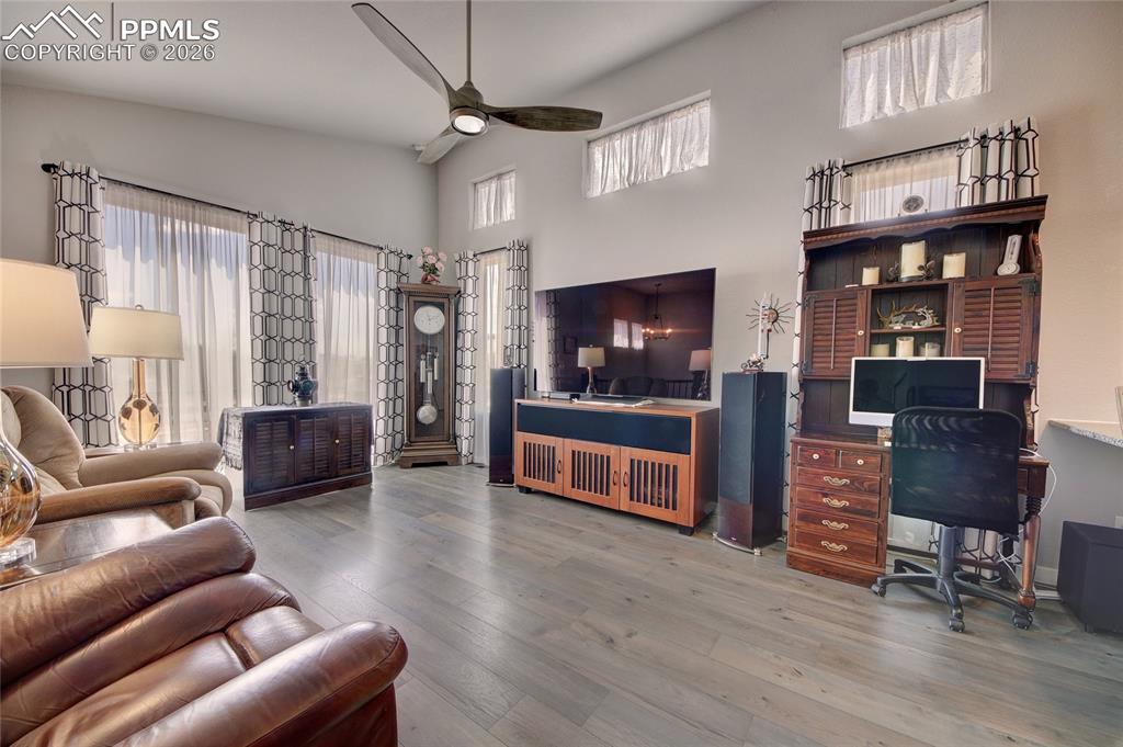 Image 14 of 25: Living room with ceiling fan