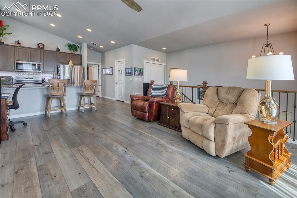 Image 15 of 25: Living room show casing lvt floors