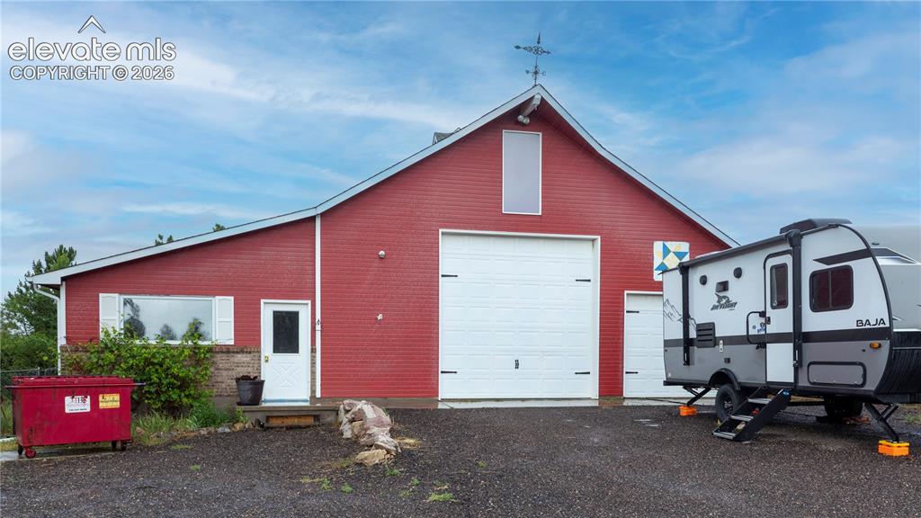 Image 33 of 46: RV Garage with Attached shop