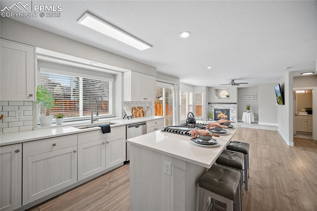 Image 10 of 46: Spacious eat in kitchen with quartz counter tops, gas range. 