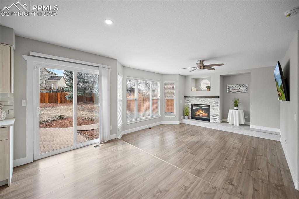 Image 15 of 46: Walk out to fully fenced back yard with patio. 