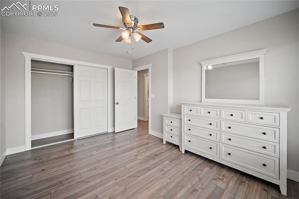 Image 30 of 46: Upstairs bedroom with laminate flooring.