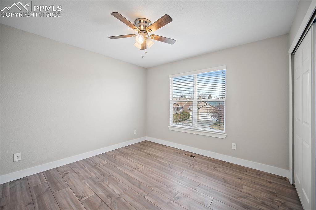 Image 31 of 46: Upstairs bedroom with laminate flooring. 
