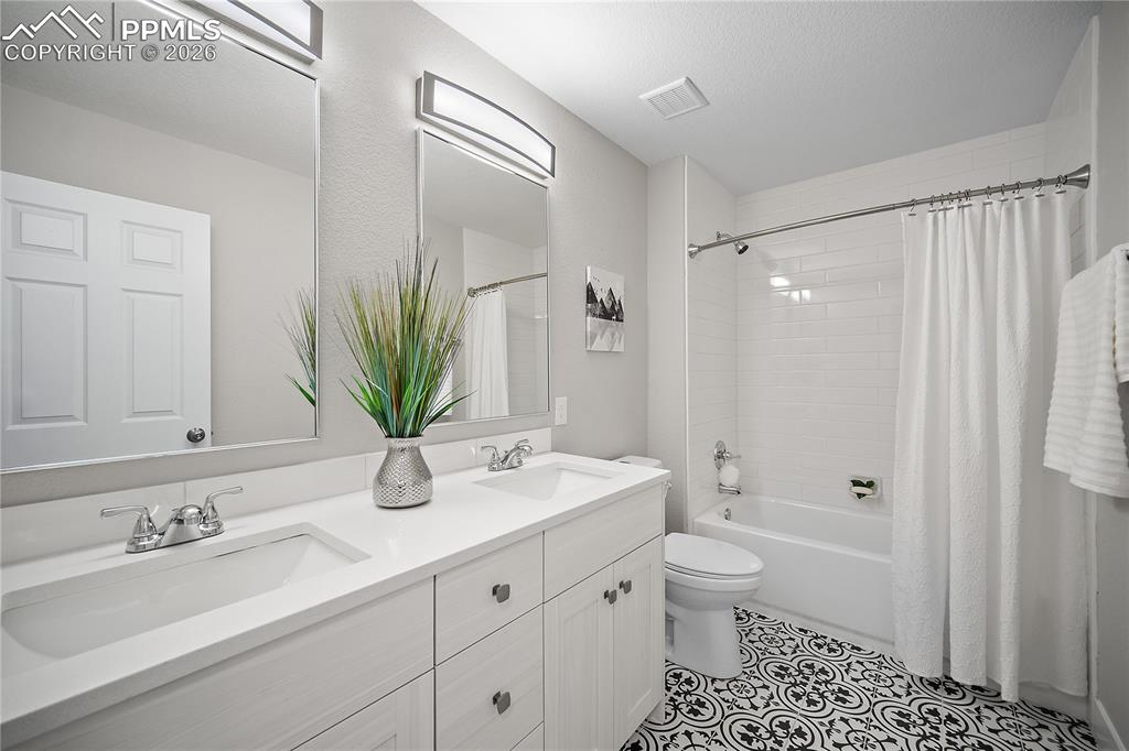 Image 32 of 46: Updated upstairs full bath with double vanity. 