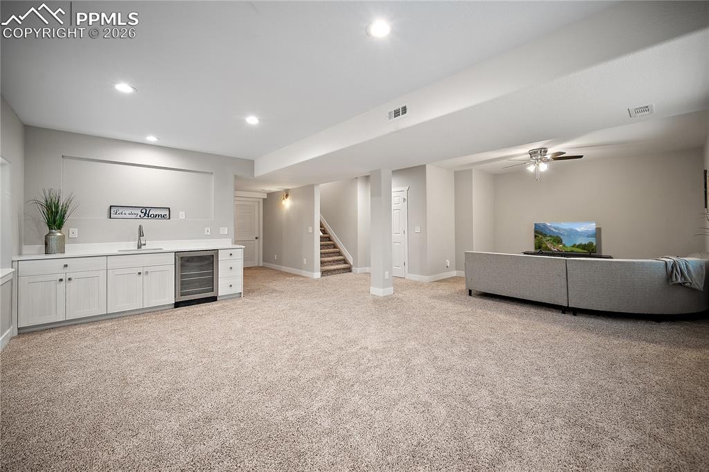 Image 34 of 46: Finished basement with newer carpet, wet bar and endless possibilities. 