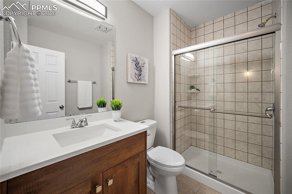 Image 37 of 46: Basement 3/4 bath with newer vanity and sink. 