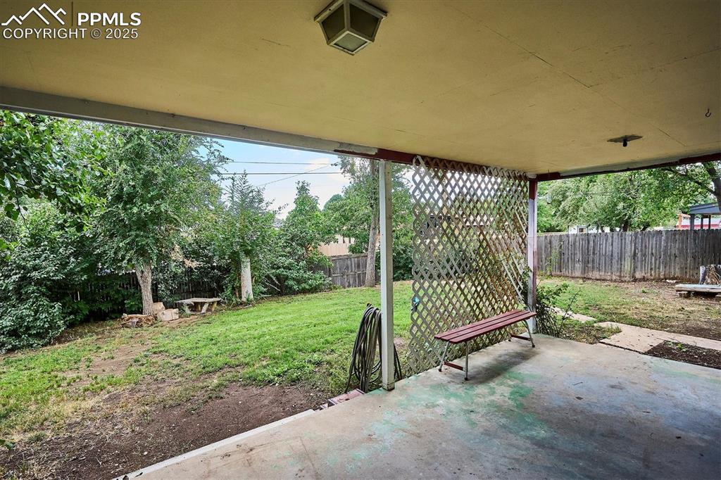 Image 19 of 19: Fenced backyard featuring a patio