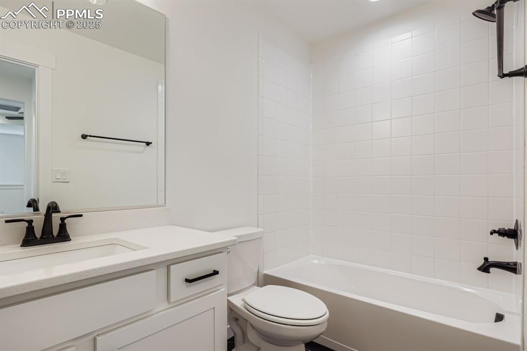 Image 22 of 28: Full bathroom with vanity and bathtub / shower combination
