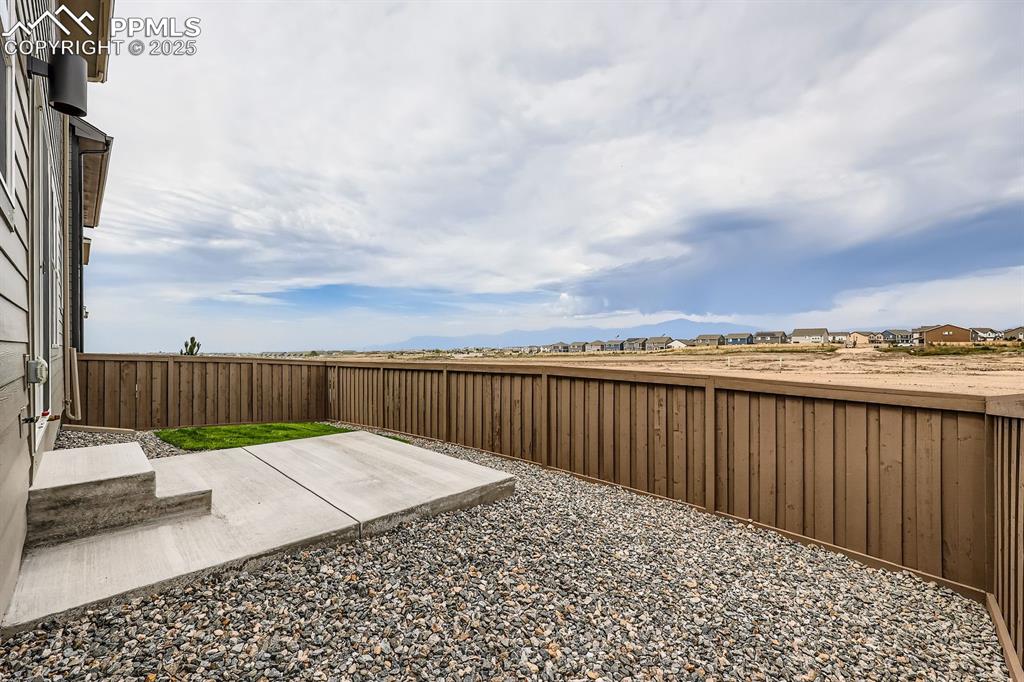 Image 26 of 28: Fenced backyard featuring a patio