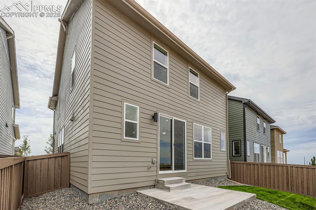 Image 27 of 28: Rear view of house featuring entry steps