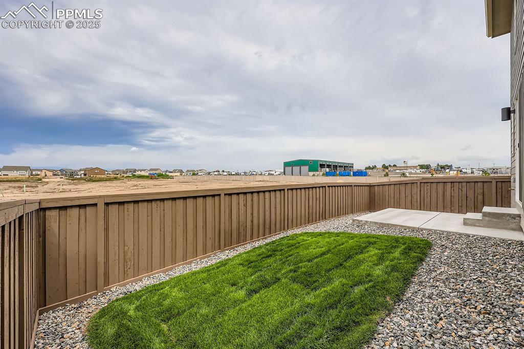 Image 28 of 28: View of fenced backyard