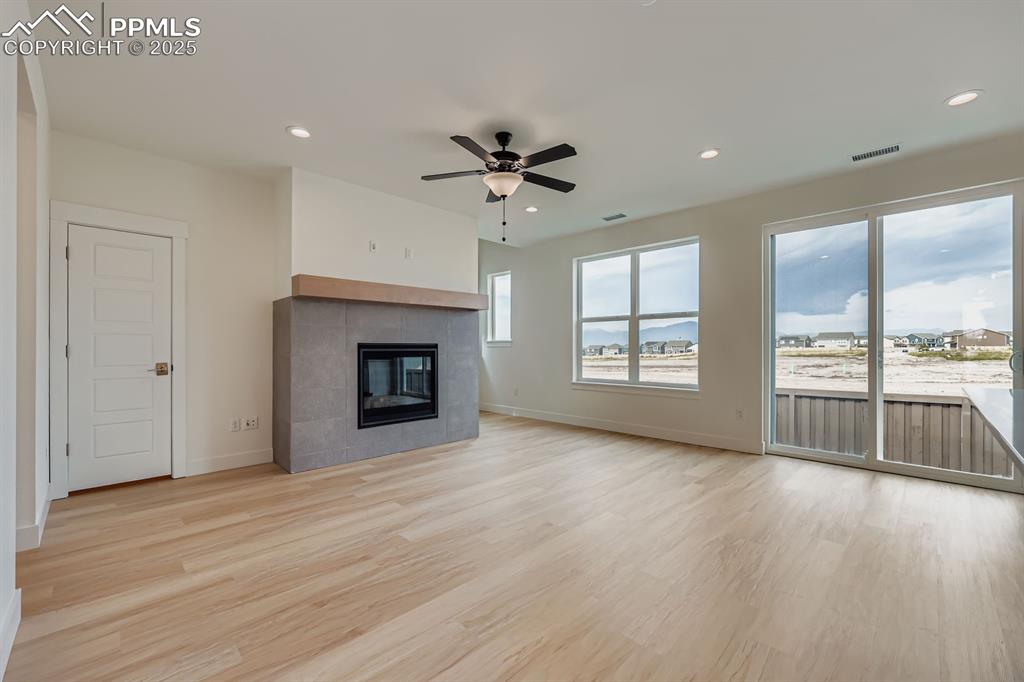 Image 7 of 28: Unfurnished living room with light wood-style floors, recessed lighting, ce
