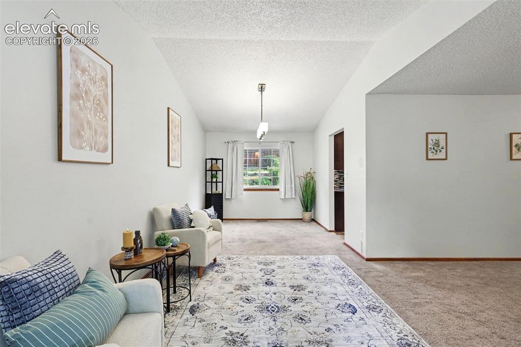 Image 10 of 41: Living area from the window nook w/ hallway and kitchen entry on the right