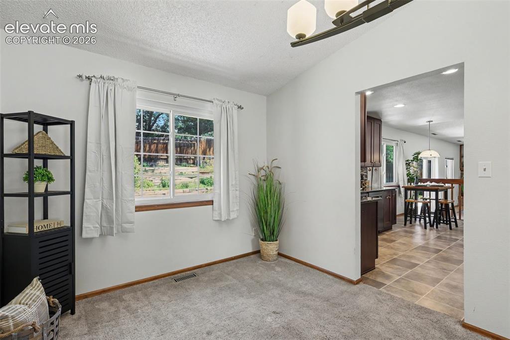 Image 15 of 41: Designated dining area w/ kitchen entry on the right