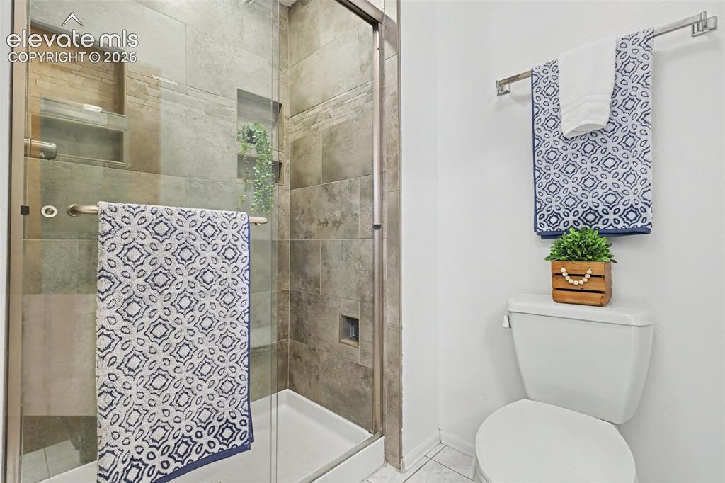 Image 28 of 41: Primary bathroom with tiled shower