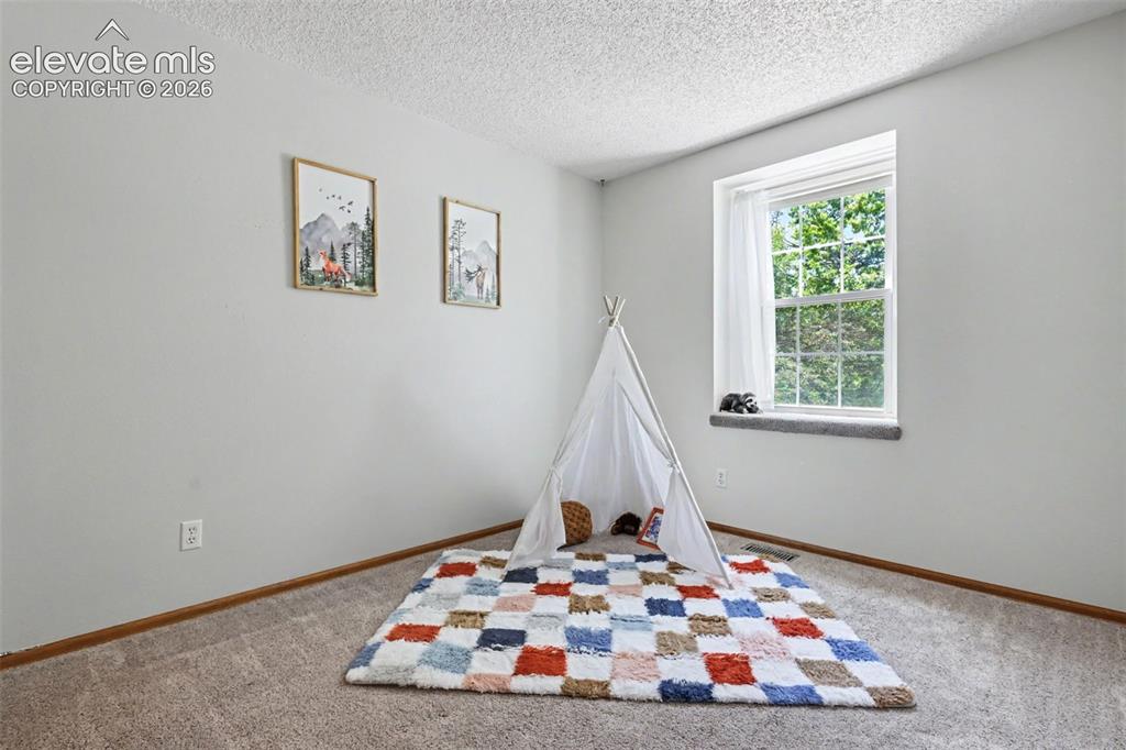 Image 30 of 41: Bedroom 2 w/ carpeted window seat